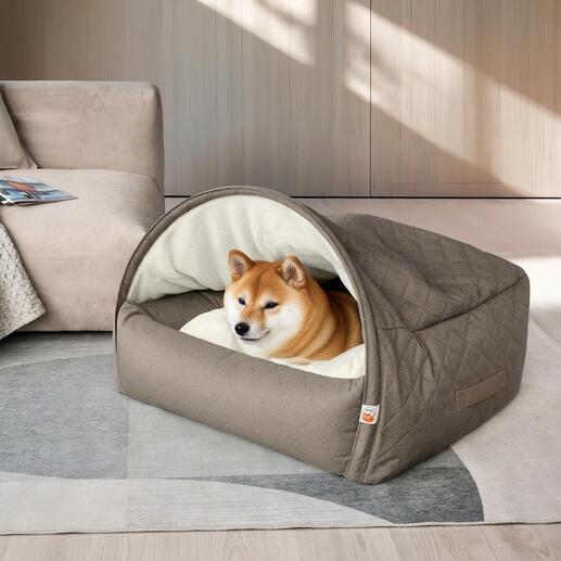Shiba Inu in einer stylischen Kuschelhöhle aus grauem Stoff