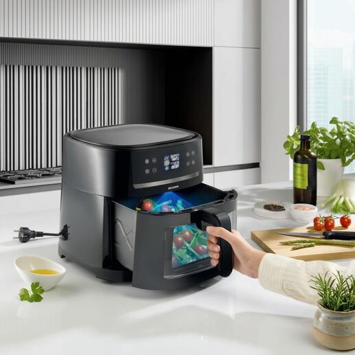 Airfryer mit KI-Technologie in einer modernen Küche, Lebensmittel werden vorbereitet.
