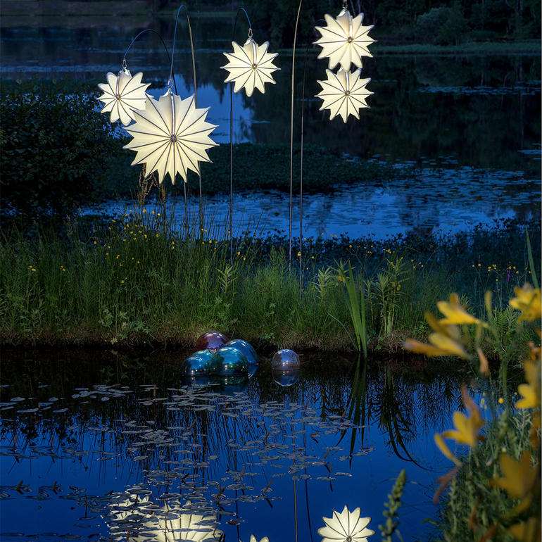 Barlooon Allwetter Lampions in verschiedenen Formen leuchten am Wasser.