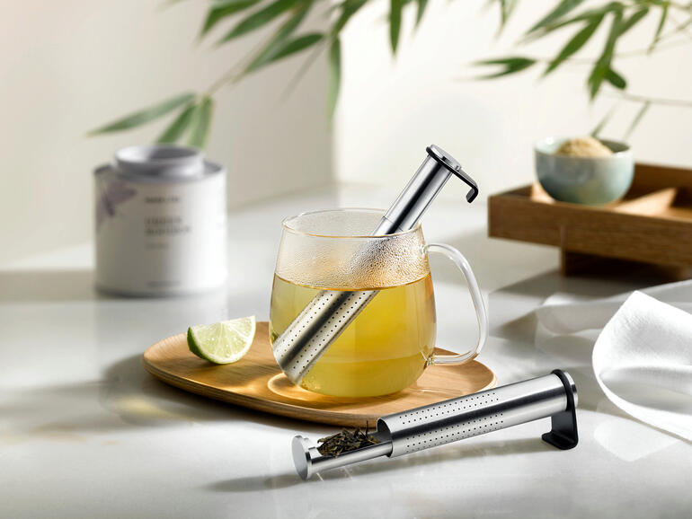 Aroma-Langrohr-Teefilter in einer Teetasse mit Limette