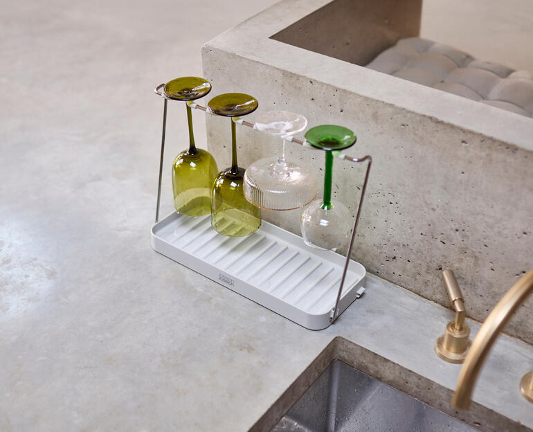 Weinglas Abtropfgestell mit mehreren Gläsern auf einer Arbeitsplatte.