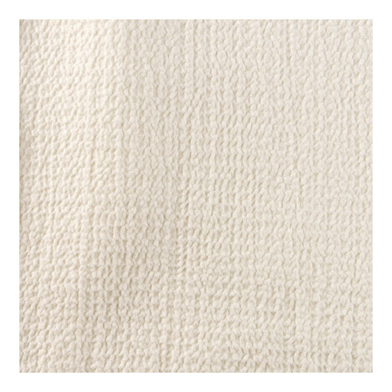 Glatte hellbeige Stoffoberfläche der Baumwoll-Kaschmir-Bluse.